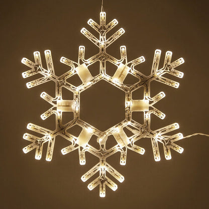 20-inch Kringle Traditions folding Christmas snowflake with 70 steady warm white LED lights hanging on a decorated front porch at night