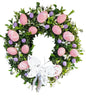 Grapevine Easter wreath with colorful eggs, greenery and a white butterfly silhouette 