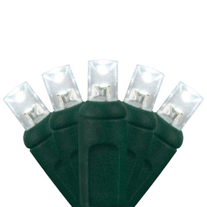 Close-up of cool white 5mm wide angle LED Christmas lights on green wire