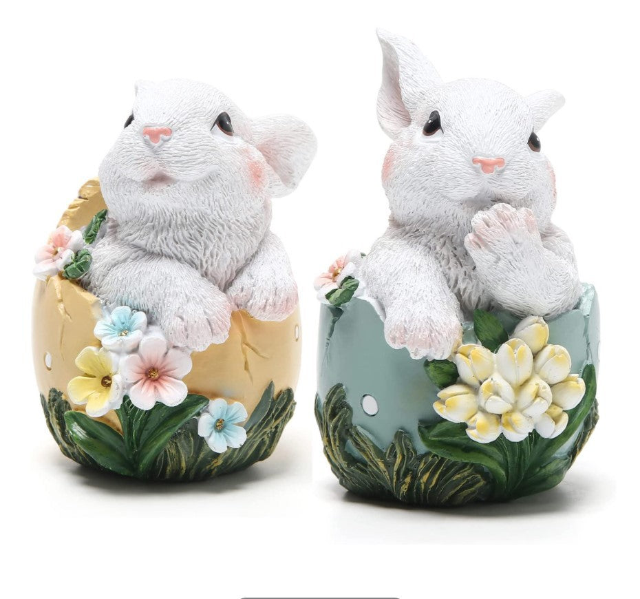 decorative figurines of white bunnies inside Easter eggs with floral designs resin decoration