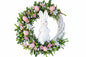 Decorative white grapevine Easter wreath with a white rabbit figure, pink eggs, and flowers