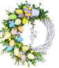 Grapevine Easter wreath with colorful eggs and a white bunny silhouette 