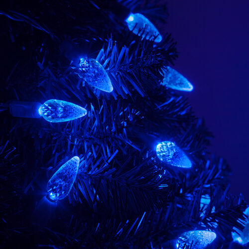 Blue C6 Strawberry LED Christmas string lights glowing on a Christmas tree