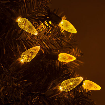 Gold C6 Strawberry LED Christmas string lights glowing on a Christmas tree