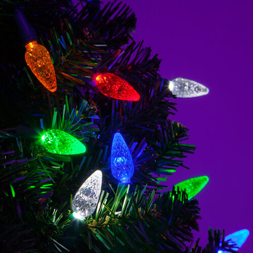 Multicolor C6 Strawberry Christmas lights with red, blue, green, gold and cool white LEDs on a Christmas tree