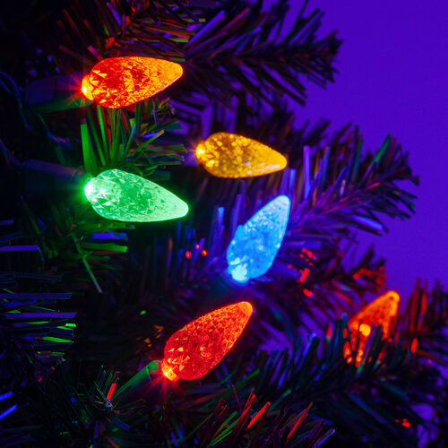 Multicolor C6 Strawberry Christmas lights with red, blue, green, gold and amber LEDs on a Christmas tree
