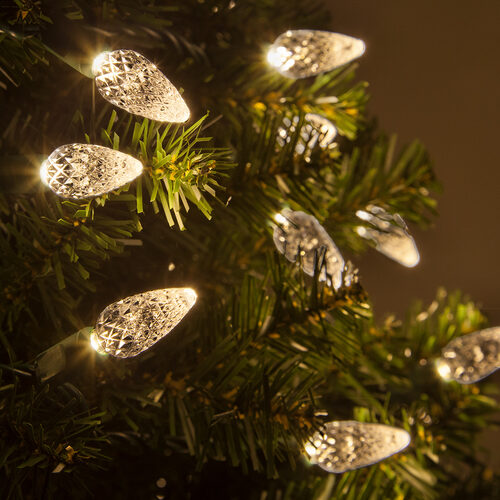 Warm white C6 Strawberry LED Christmas string lights glowing on a Christmas tree