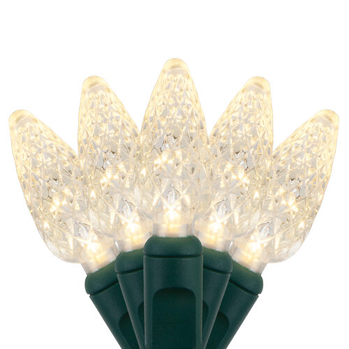 Warm white C6 Strawberry LED Christmas string lights glowing on a Christmas tree