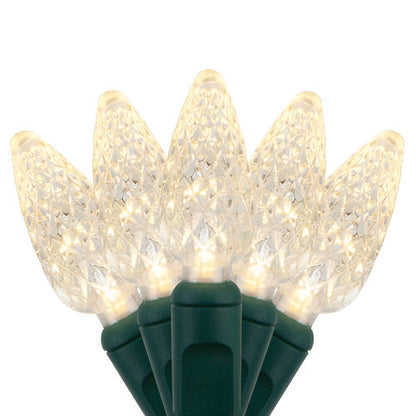 Warm white C6 Strawberry LED Christmas string lights glowing on a Christmas tree