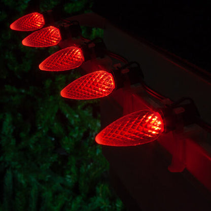 Red C9 OptiCore LED Christmas string lights on green wire