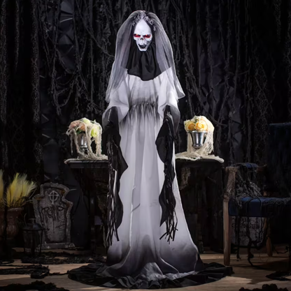 Halloween decoration of a ghostly figure in a white gown with black accents, standing in a dark, eerie setting.