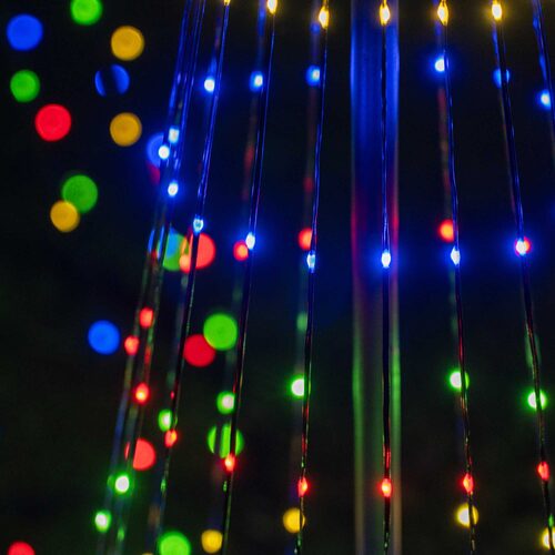 Close-up of red, green, blue and warm white multicolor LED lights on a black-wire animated Christmas light show tree.