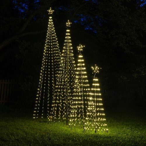 Wintergreen Lighting warm white animated LED Christmas light show trees in multiple sizes displayed outdoors with glowing star toppers.