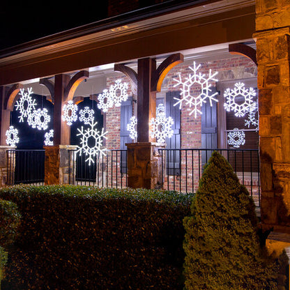 Decorative snowflake lights on a house exterior at night
