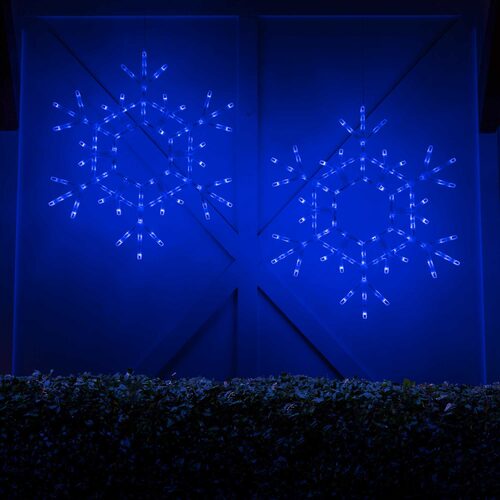 Two matching giant 3 Ft blue LED folding snowflakes illuminated together in a festive outdoor Christmas display.